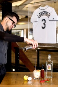 "Learning about spirits enhances my need to know. It Intrigues me and made me realize I'm a history buff. After work, I go home and read books about booze, then create new drinks." Mixologist, Chuck Cooper, pouring a Hair Of The Dog.